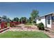 Spacious backyard with patio, perfect for relaxing and entertaining at 2401 W Jewell Ave, Denver, CO 80219