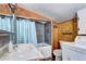 Rustic bathroom with knotty pine walls, tub/shower and marble countertop at 2401 W Jewell Ave, Denver, CO 80219
