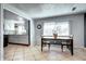 Cozy dining room with a wooden table and chairs, ceramic tile flooring, and adjacent kitchen at 2401 W Jewell Ave, Denver, CO 80219