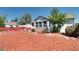 Exterior of a charming house with red bark landscaping, unique design, and a welcoming front yard with red fence at 2401 W Jewell Ave, Denver, CO 80219