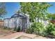 Charming front exterior with lush greenery, gated entry and well-maintained curb appeal at 2401 W Jewell Ave, Denver, CO 80219