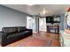 Inviting living room with hardwood floors, dark sofa, and an entertainment center at 2401 W Jewell Ave, Denver, CO 80219