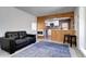 Cozy living room with wood accents, complemented by a modern black leather sofa at 2401 W Jewell Ave, Denver, CO 80219