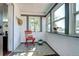Bright sun room featuring natural light, decorative windows, and a cozy chair at 2401 W Jewell Ave, Denver, CO 80219
