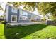 Expansive backyard showcasing a lush lawn and patio with a well-maintained privacy fence at 331 Las Lomas St, Brighton, CO 80601