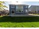 Large backyard featuring a well-kept lawn, spacious patio, and tasteful privacy fence at 331 Las Lomas St, Brighton, CO 80601