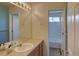 Bright bathroom featuring a large mirror and a combined tub and shower at 331 Las Lomas St, Brighton, CO 80601