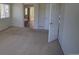 Neutral bedroom featuring neutral carpet, an open door, and a glimpse of the bathroom at 331 Las Lomas St, Brighton, CO 80601