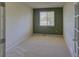 Bedroom with neutral carpet, trim, and a dark green accent wall at 331 Las Lomas St, Brighton, CO 80601