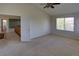 Bedroom with high ceilings, a ceiling fan, neutral carpet, a window with blinds, and an open doorway at 331 Las Lomas St, Brighton, CO 80601