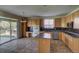 Functional kitchen featuring an island, stainless dishwasher, and a view to the back yard at 331 Las Lomas St, Brighton, CO 80601