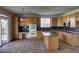 Functional kitchen featuring an island, stainless dishwasher, and a lot of cabinets at 331 Las Lomas St, Brighton, CO 80601