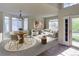 Bright living room featuring a round dining table, comfortable seating, and large windows at 331 Las Lomas St, Brighton, CO 80601