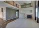 Spacious living room with tall ceilings, fireplace, neutral carpet, and an open loft area at 331 Las Lomas St, Brighton, CO 80601