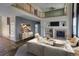 Spacious living room with fireplace, high ceilings, and a wooden railing at 331 Las Lomas St, Brighton, CO 80601