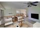 Cozy upstairs living area with comfortable seating, a television, and view of the stairwell at 331 Las Lomas St, Brighton, CO 80601