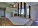 Spacious living room with tall ceilings, fireplace, neutral carpet, and large windows at 331 Las Lomas St, Brighton, CO 80601