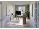 Bright office space featuring a glass desk, neutral decor, and a large window for natural light at 331 Las Lomas St, Brighton, CO 80601