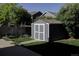 Well-maintained backyard shed with double doors and landscaped surroundings at 331 Las Lomas St, Brighton, CO 80601