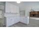 White kitchen cabinets and quartz countertops with an open concept to the living room at 615 S Oakland St, Aurora, CO 80012