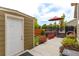 Exterior patio, with a shed, umbrella table set and red roses at 3936 Costillo Ct, Brighton, CO 80601