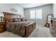 Spacious bedroom boasts large bed and a light filled window with shutters at 3936 Costillo Ct, Brighton, CO 80601
