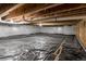 Encapsulated crawl space, visible vapor barrier, beams and plumbing at 3936 Costillo Ct, Brighton, CO 80601