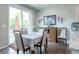 This dining area features a modern chandelier and access to a patio deck at 3936 Costillo Ct, Brighton, CO 80601