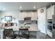 Kitchen with granite countertops, stainless steel appliances, white cabinets and barstool seating at 3936 Costillo Ct, Brighton, CO 80601