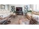 Hardwood floors, modern entertainment center with fireplace and comfortable furniture in the living room at 3936 Costillo Ct, Brighton, CO 80601
