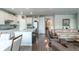 Open concept layout with eat in kitchen, bar stool seating and an expansive living room at 3936 Costillo Ct, Brighton, CO 80601