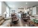 Open concept kitchen and living space with leather furniture and hardwood floors at 3936 Costillo Ct, Brighton, CO 80601