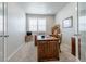 Cozy office space featuring a large wooden desk, window with blinds, and neutral paint at 3936 Costillo Ct, Brighton, CO 80601