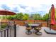 Relaxing patio area with outdoor furniture, umbrella, and backyard views at 3936 Costillo Ct, Brighton, CO 80601