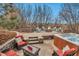 Well-designed backyard featuring a hot tub, flagstone patio, outdoor furniture, and a cozy fire pit area at 9132 Scenic Pine Dr, Parker, CO 80134