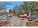 A stone patio features a fire pit with Adirondack chairs and a hot tub with lounge seating at 9132 Scenic Pine Dr, Parker, CO 80134
