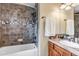 Bathroom featuring tiled shower and backsplash, wood vanity, and modern fixtures at 9132 Scenic Pine Dr, Parker, CO 80134