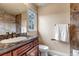 Elegant bathroom showcasing marble counters, wood cabinetry, and a tiled shower at 9132 Scenic Pine Dr, Parker, CO 80134