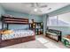 Comfortable bedroom with bunk beds, storage cubes, a bench and bright natural light at 9132 Scenic Pine Dr, Parker, CO 80134