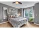 Stylish bedroom with gray walls, cozy bedding, desk, and plenty of natural light at 9132 Scenic Pine Dr, Parker, CO 80134