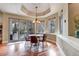 Bright dining area with deck access, multiple windows, and trey ceiling detail at 9132 Scenic Pine Dr, Parker, CO 80134