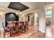 Formal dining room with tray ceiling, hardwood floors, and elegant chandelier at 9132 Scenic Pine Dr, Parker, CO 80134