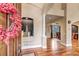 Inviting foyer with hardwood floors, architectural details, and views into the dining area at 9132 Scenic Pine Dr, Parker, CO 80134