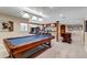 Spacious game room with a pool table and foosball table at 9132 Scenic Pine Dr, Parker, CO 80134