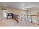 Bright hallway featuring decorative chandelier, desk and staircase with iron railings at 9132 Scenic Pine Dr, Parker, CO 80134