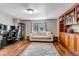 Living room with light colored hardwood flooring, sofa and built-in wooden shelves at 9132 Scenic Pine Dr, Parker, CO 80134