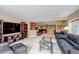 Living room with leather sofa, wet bar and game room views at 9132 Scenic Pine Dr, Parker, CO 80134