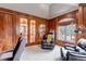 Another view of the executive office with wood paneled walls and french doors at 9132 Scenic Pine Dr, Parker, CO 80134