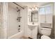 Basement bathroom featuring a shower-over-tub, contemporary mirror and a white vanity, offering a clean, modern look at 3515 N Elizabeth St, Denver, CO 80205