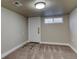 Finished basement area featuring modern carpeting, neutral walls, and a discreetly placed access door at 915 N Irving St, Denver, CO 80204